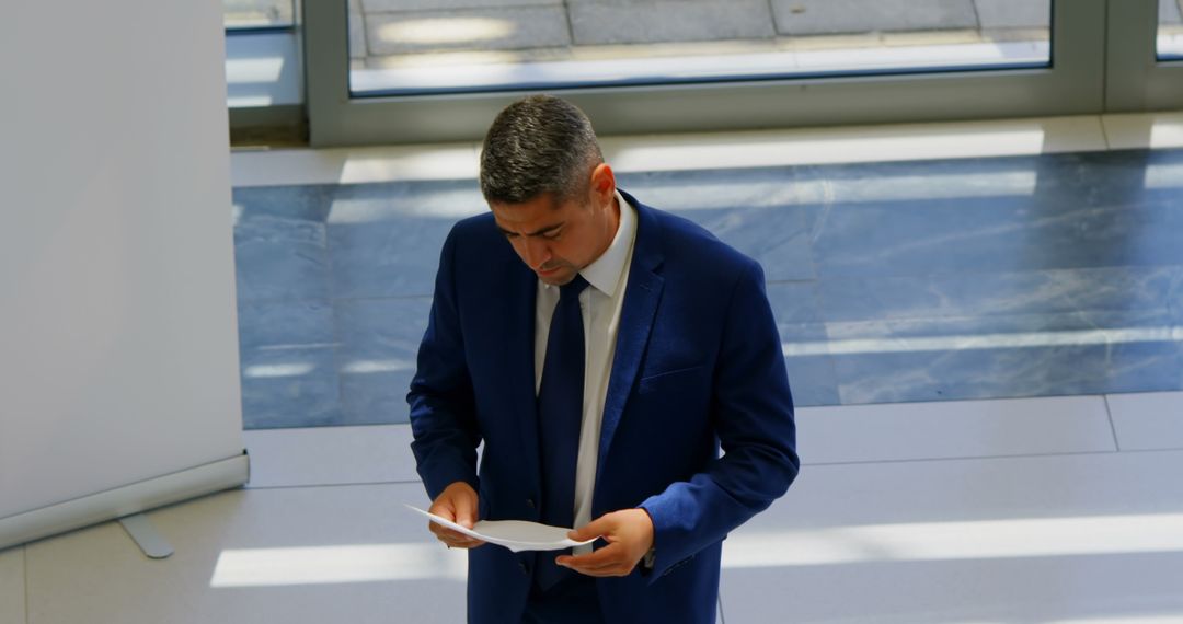 Businessman Preparing for Presentation in Office Setting