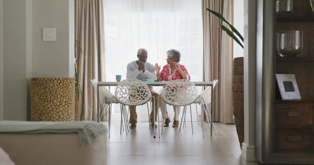Senior Biracial Couple Enjoying Conversation at Home