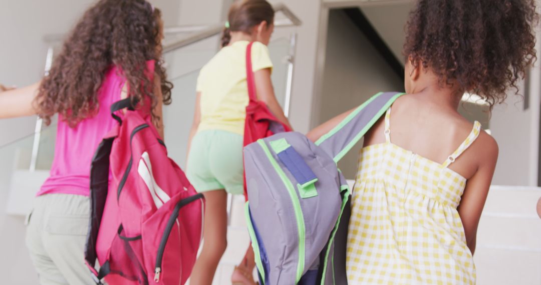 Group of Children with Backpacks Going Upstairs Inside School Building - Free Images, Stock Photos and Pictures on Pikwizard.com