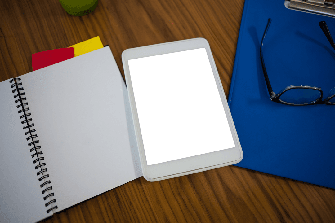 Digital Tablet on Clear Desk Near Notepad and Glasses