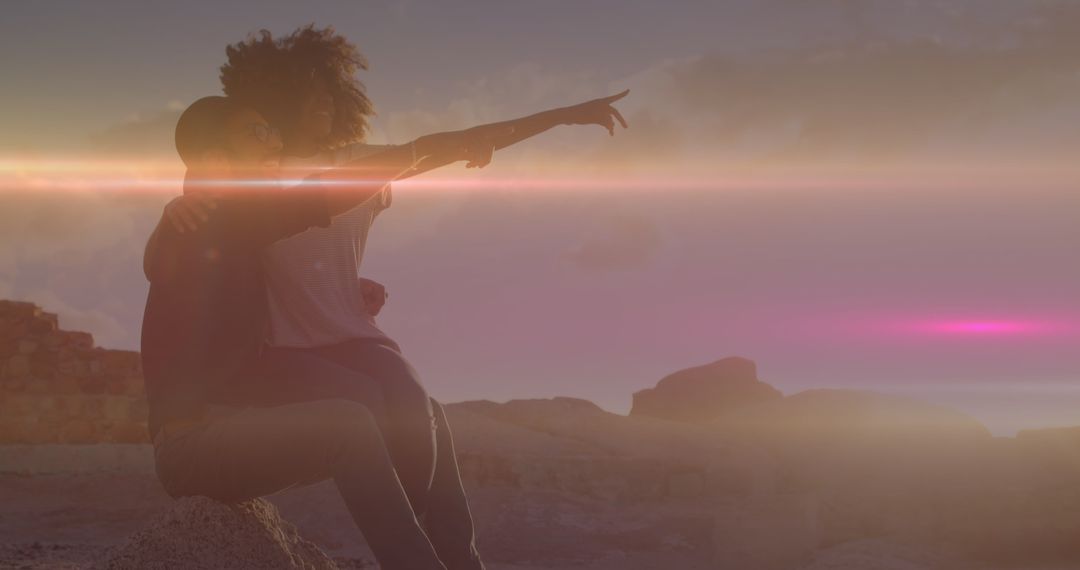 Romantic Sunset Moment Couple Pointing with Lens Flare