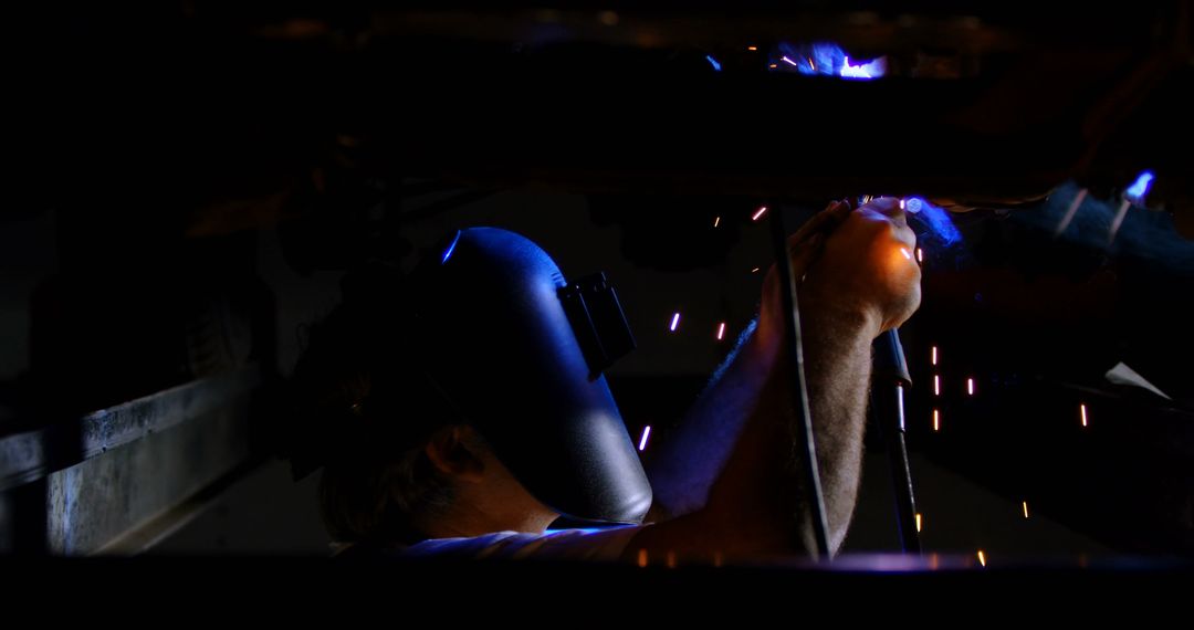 Welder Working in Dark Workshop, Sparking Light with Welding Torch - Free Images, Stock Photos and Pictures on Pikwizard.com