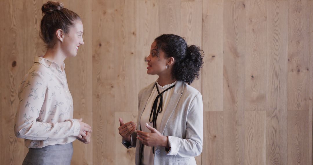 Two Professional Women Engaging in a Discussion in Office - Free Images, Stock Photos and Pictures on Pikwizard.com