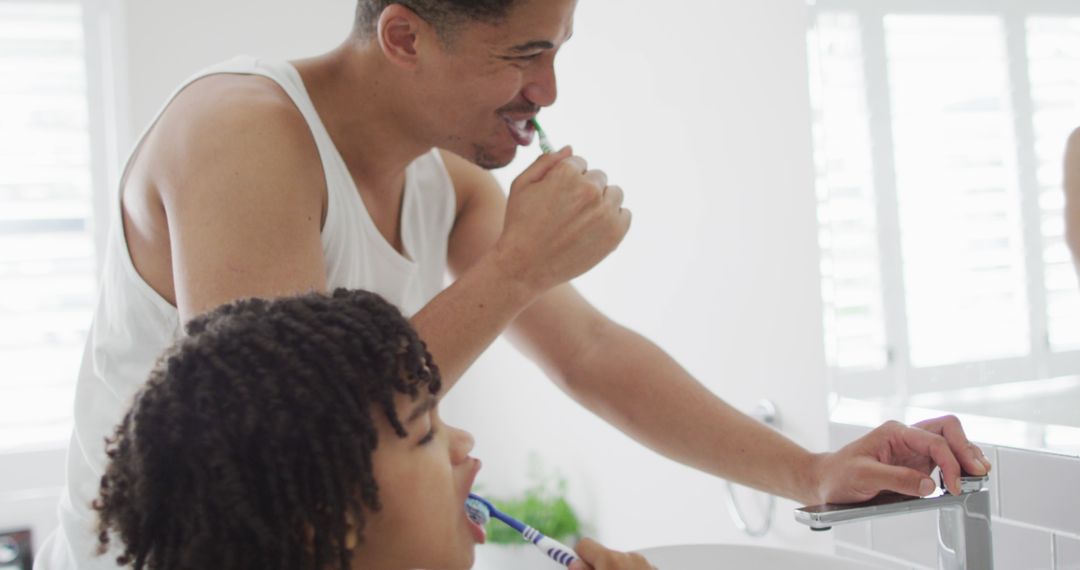 Father and Son Brushing Teeth Together in Morning Routine - Free Images, Stock Photos and Pictures on Pikwizard.com