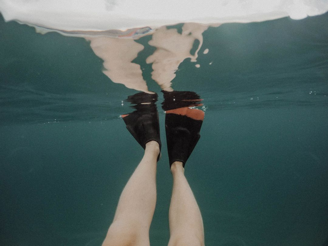 Underwater View of Swimmer's Legs with Black Fins - Free Images, Stock Photos and Pictures on Pikwizard.com