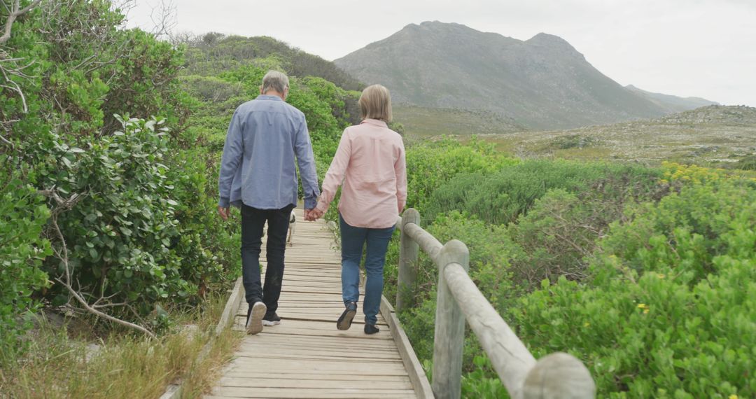 Senior Couple Enjoying Nature Walk on Scenic Boardwalk