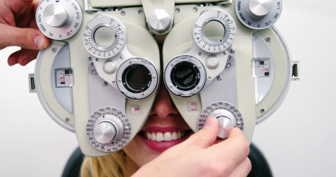 Optometrist Adjusting Phoropter During Eye Exam with Smiling Patient - Free Images, Stock Photos and Pictures on Pikwizard.com