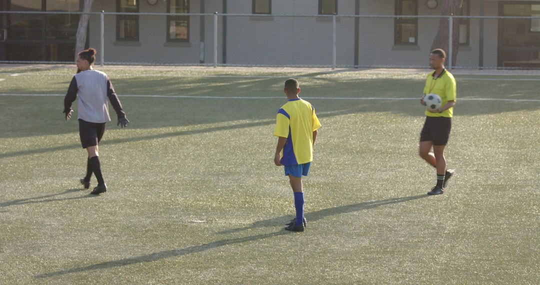 Youth Soccer Team Discussing Strategy on Sunny Day