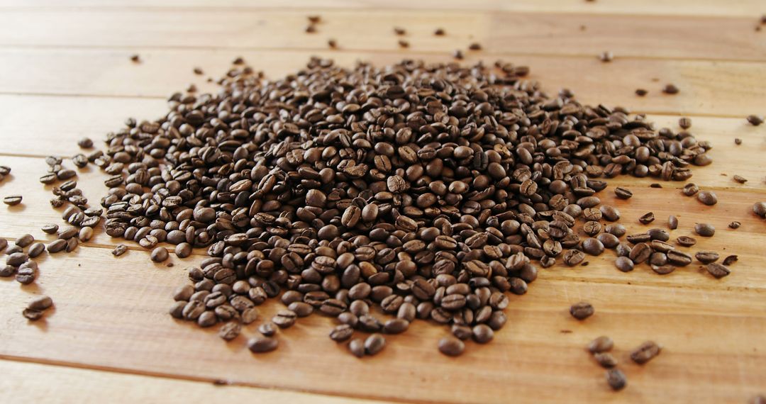 Heap of Roasted Coffee Beans on Wooden Table Top - Free Images, Stock Photos and Pictures on Pikwizard.com