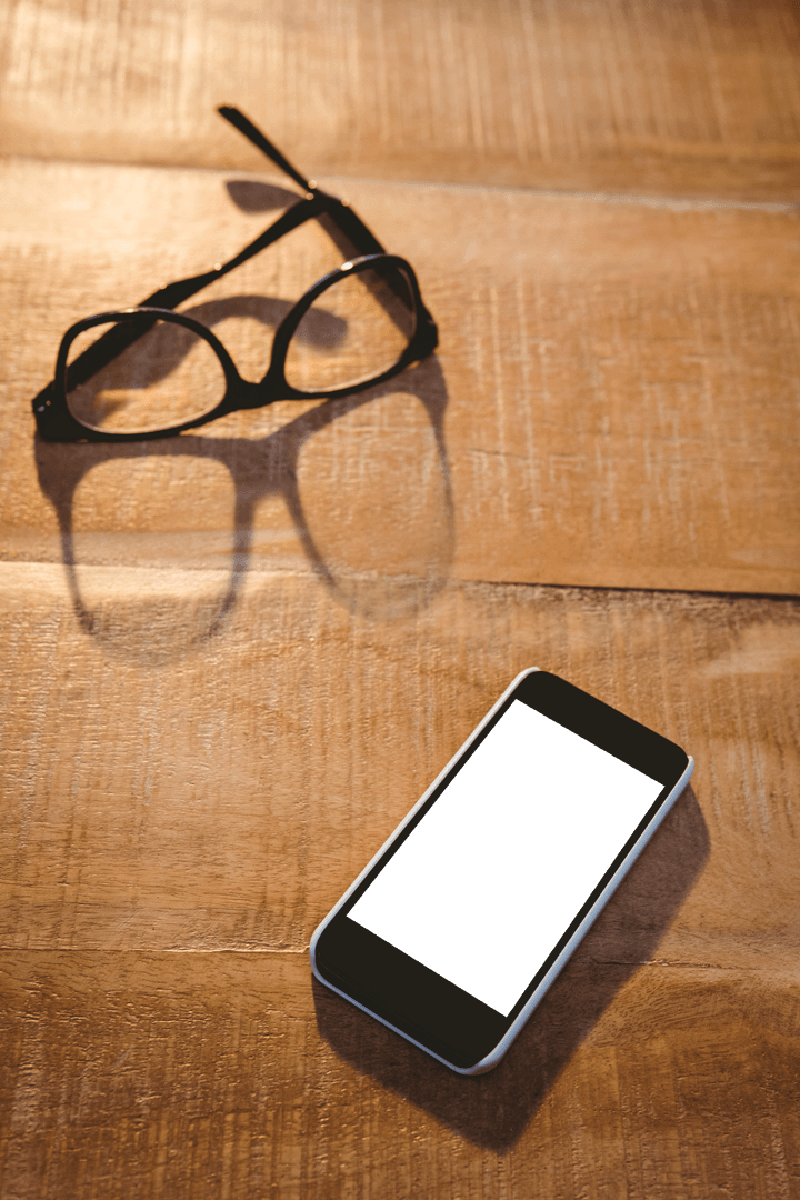 Transparent Glasses and Smartphone on Wooden Surface