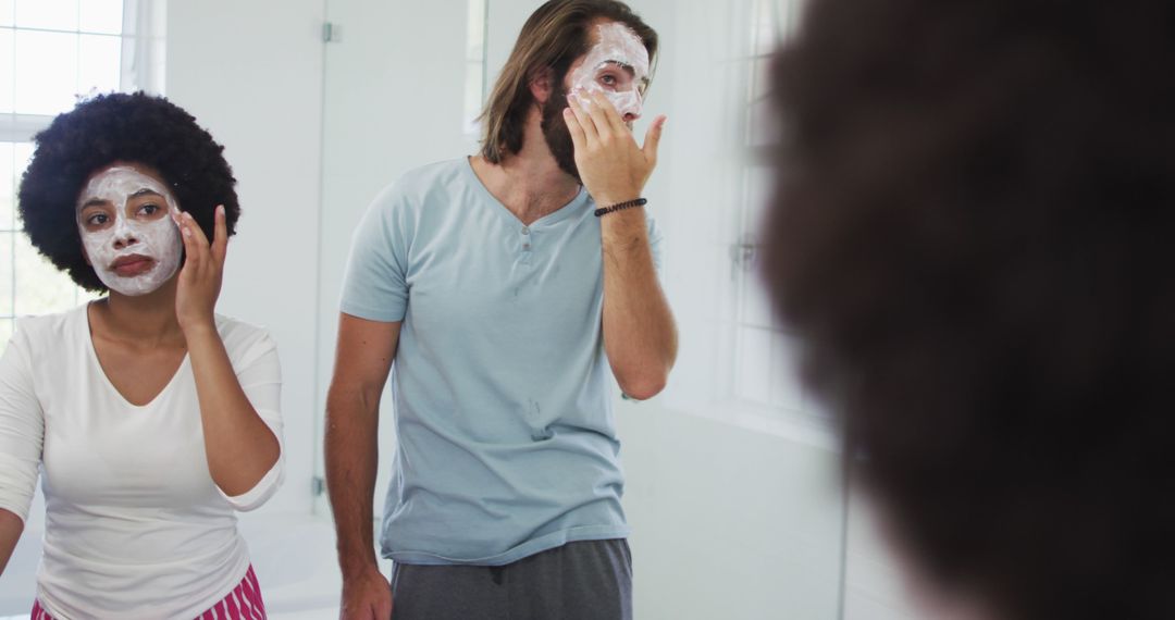 Couple Applying Face Masks Together in Bathroom - Free Images, Stock Photos and Pictures on Pikwizard.com