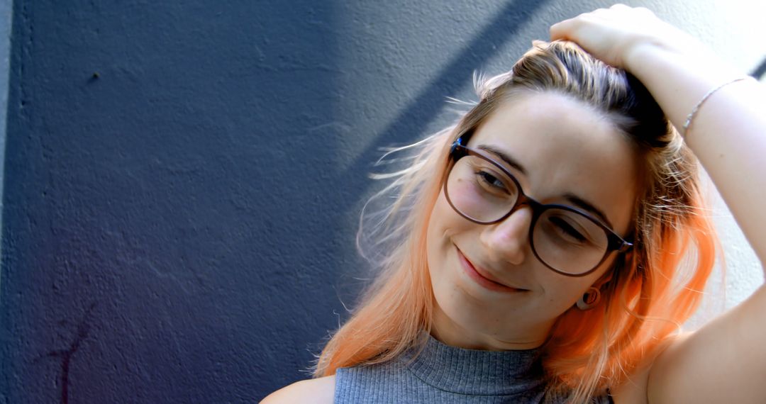 Smiling Young Woman with Glasses and Colored Hair Relaxing Outdoors - Free Images, Stock Photos and Pictures on Pikwizard.com