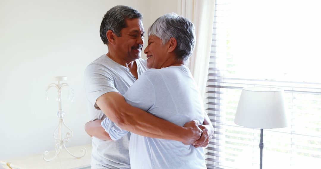 Senior Latino Couple Embracing in Cozy Home Setting