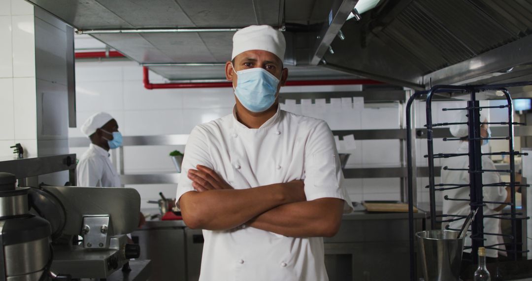 Professional Chef in Commercial Kitchen Wearing Medical Mask and Uniform - Free Images, Stock Photos and Pictures on Pikwizard.com