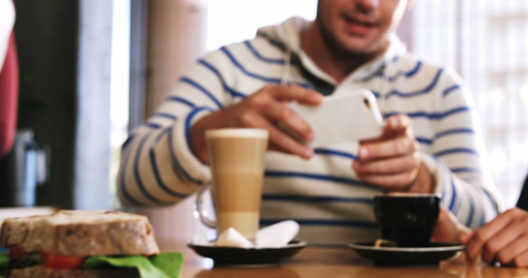 Man Taking Photo of Hot Coffee and Sandwich in Cafe - Free Images, Stock Photos and Pictures on Pikwizard.com