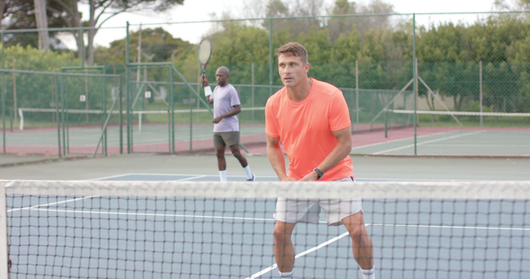 Two Men Playing Doubles Tennis on Outdoor Court - Free Images, Stock Photos and Pictures on Pikwizard.com