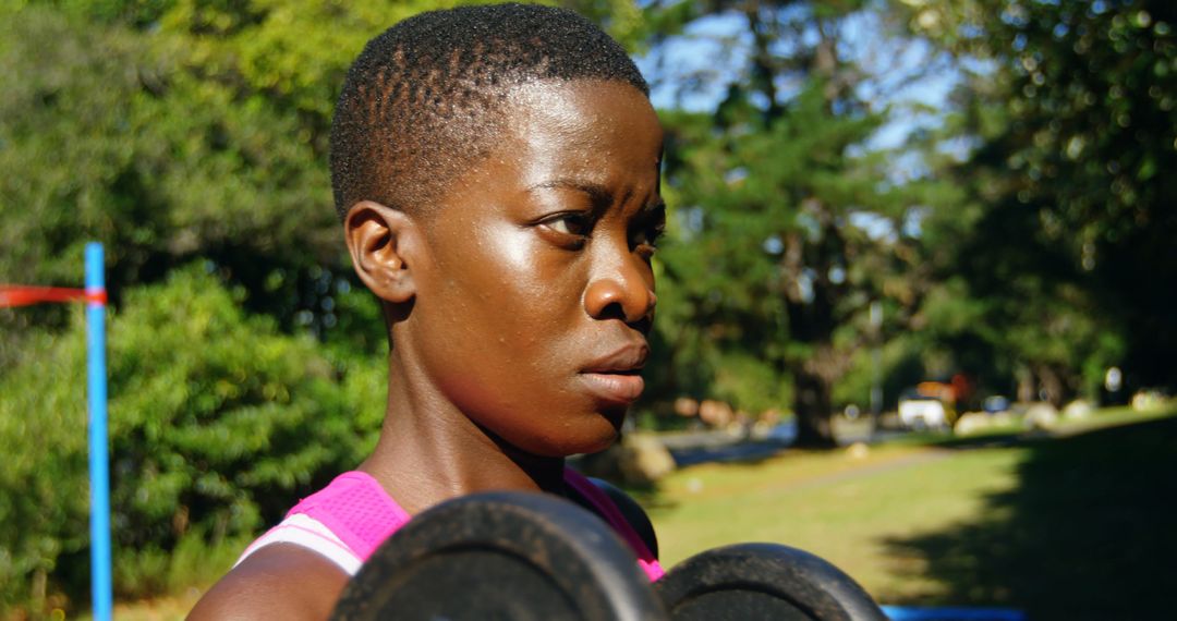 Focused African Woman Weightlifting Outdoors in Daylight - Free Images, Stock Photos and Pictures on Pikwizard.com