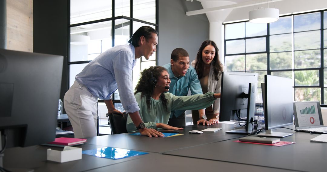 Diverse Colleagues Collaborating Enthusiastically in Modern Office