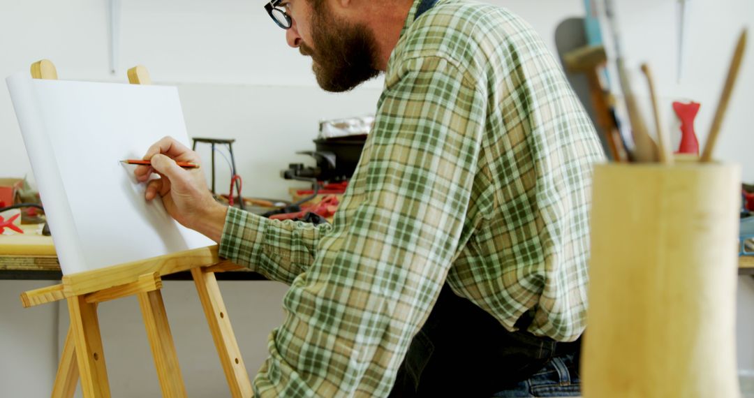 Man Drawing on Canvas in Art Studio - Free Images, Stock Photos and Pictures on Pikwizard.com