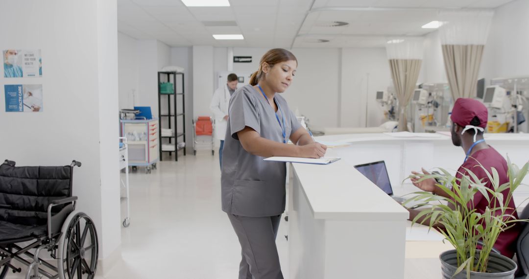 Medical Staff Working at Busy Hospital Nurse Station - Free Images, Stock Photos and Pictures on Pikwizard.com