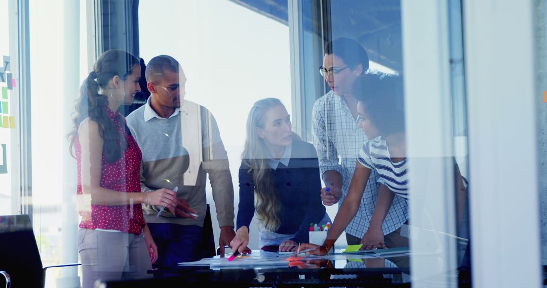 Diverse Team Collaborating in Modern Office Environment on Project