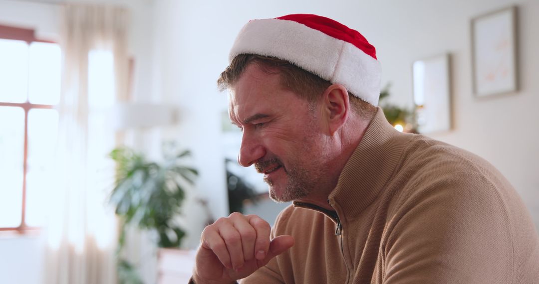 Man Wearing Santa Hat Relaxing at Home Amid Christmas Decor