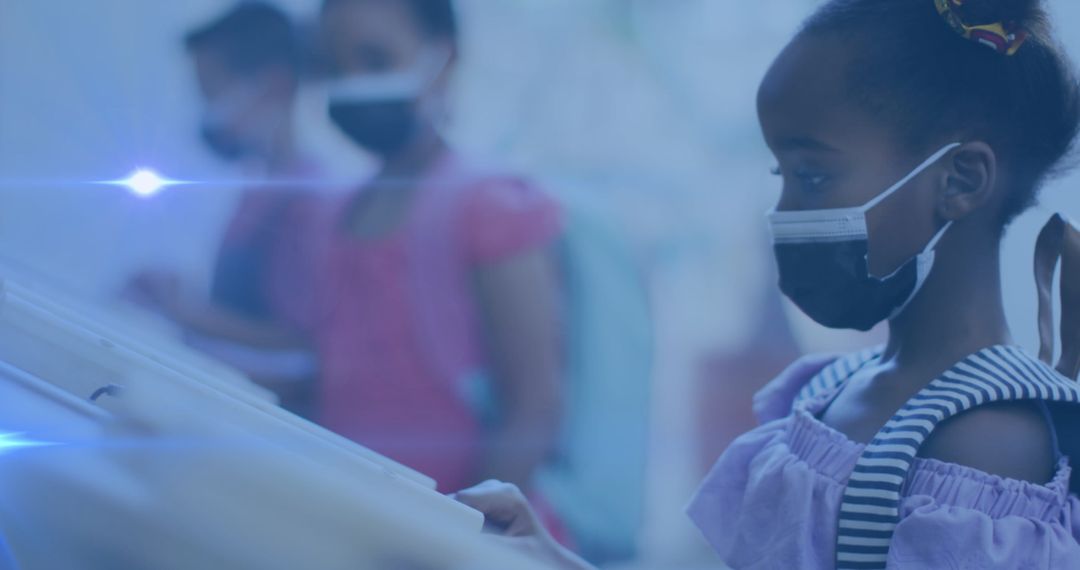 Students Wearing Face Masks Engaging with Interactive Displays in Classroom