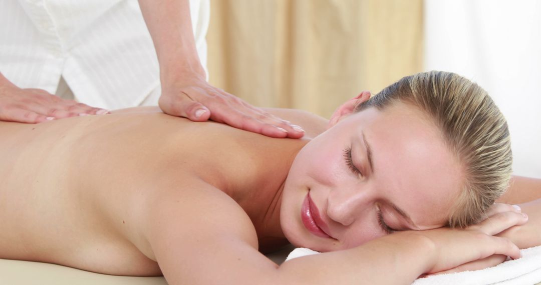 A Caucasian woman enjoys a relaxing massage from a therapist, with copy space - Free Images, Stock Photos and Pictures on Pikwizard.com