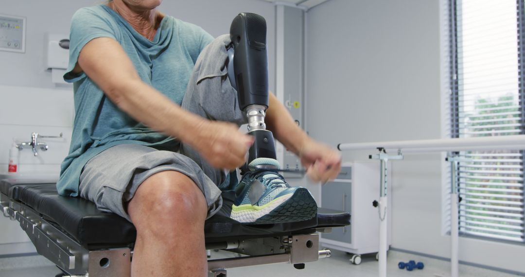 Person with Prosthetic Leg Sitting on Medical Table in Rehabilitation Clinic - Free Images, Stock Photos and Pictures on Pikwizard.com