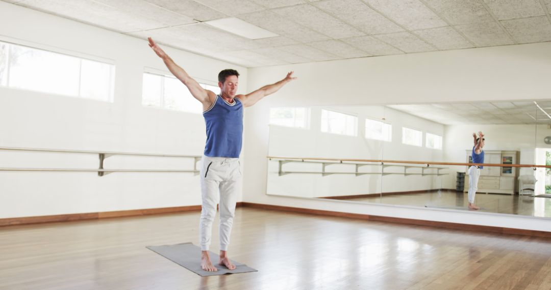 Man Practicing Yoga in Bright, Spacious Studio - Free Images, Stock Photos and Pictures on Pikwizard.com