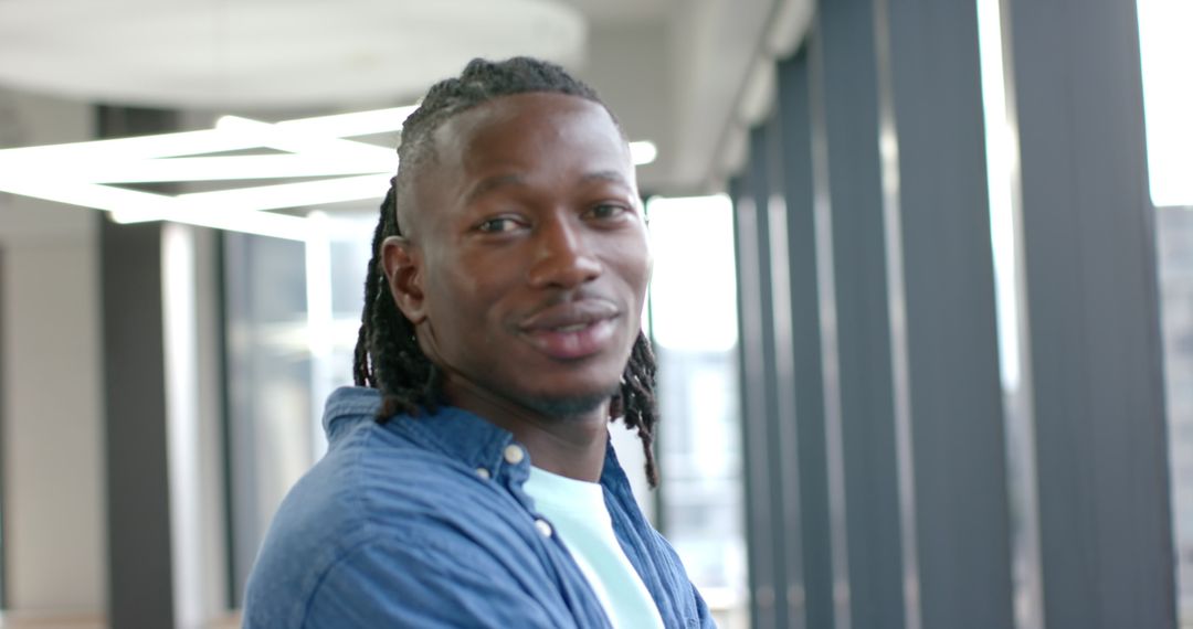 Smiling Professional in Modern Office Environment