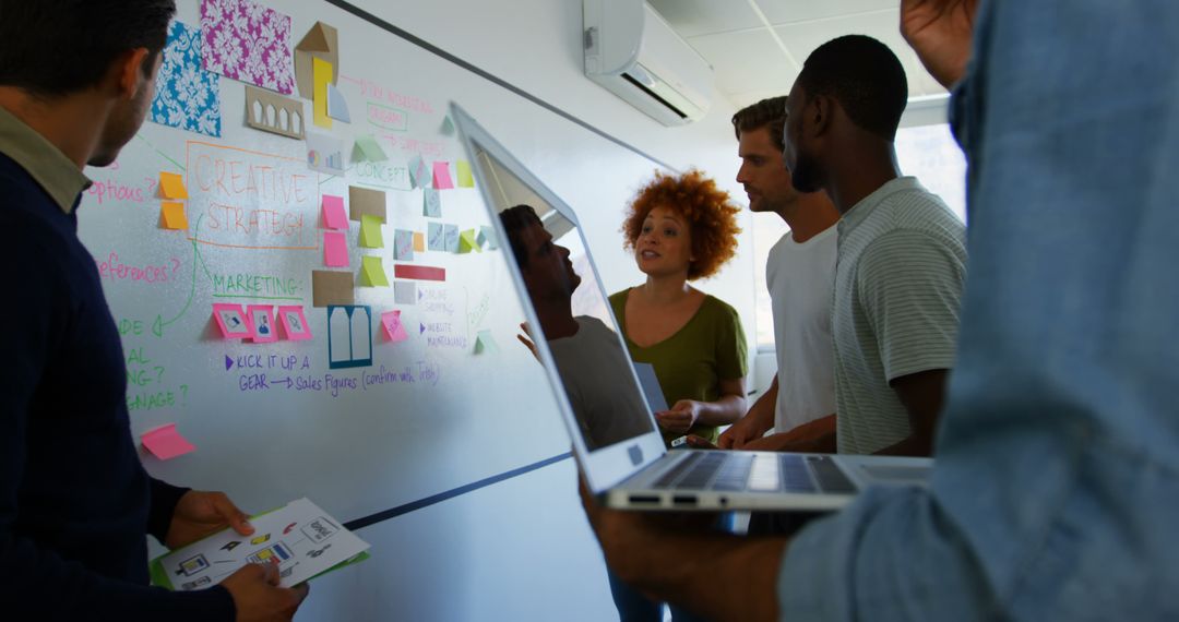 Diverse Team Brainstorming with Sticky Notes in Modern Workplace