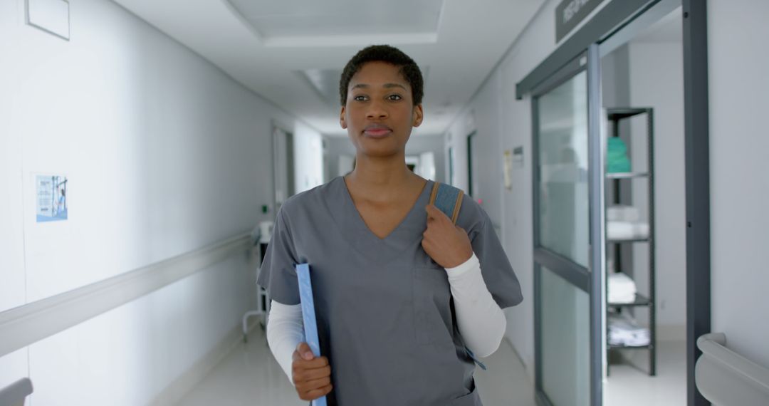 Confident Medical Professional Walking in Hospital Corridor - Free Images, Stock Photos and Pictures on Pikwizard.com