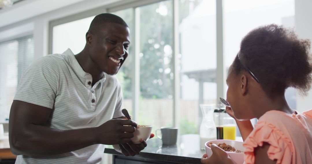 Happy African American Father and Daughter Having Breakfast Together - Free Images, Stock Photos and Pictures on Pikwizard.com