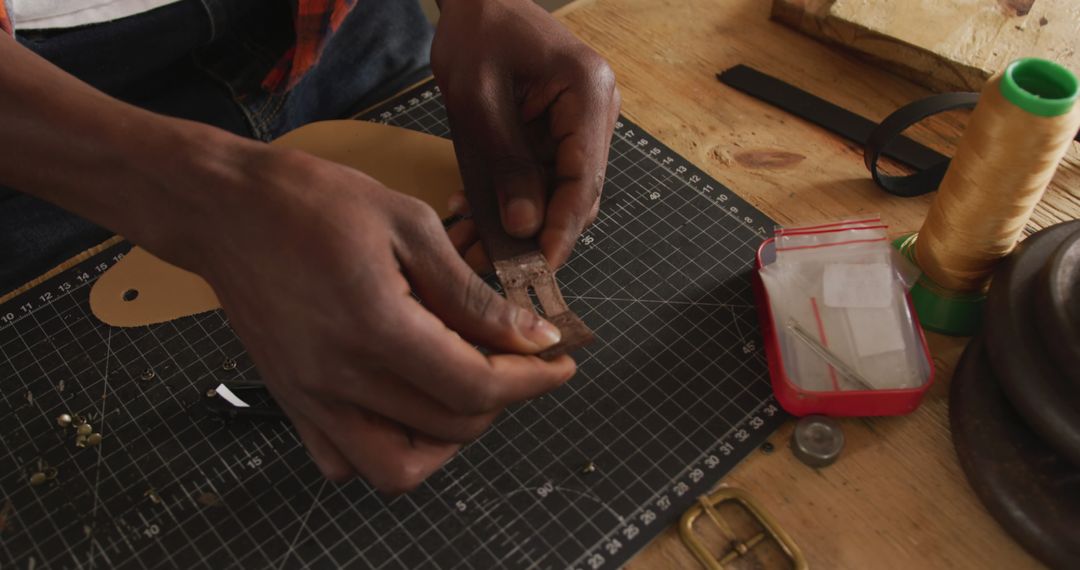 Skilled Craftsman Creating Leather Belt with Precision