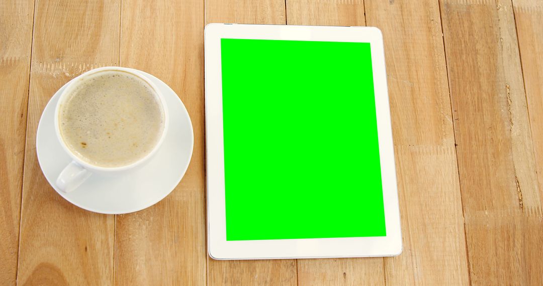 Coffee and Tablet with Green Screen on Wooden Table - Free Images, Stock Photos and Pictures on Pikwizard.com