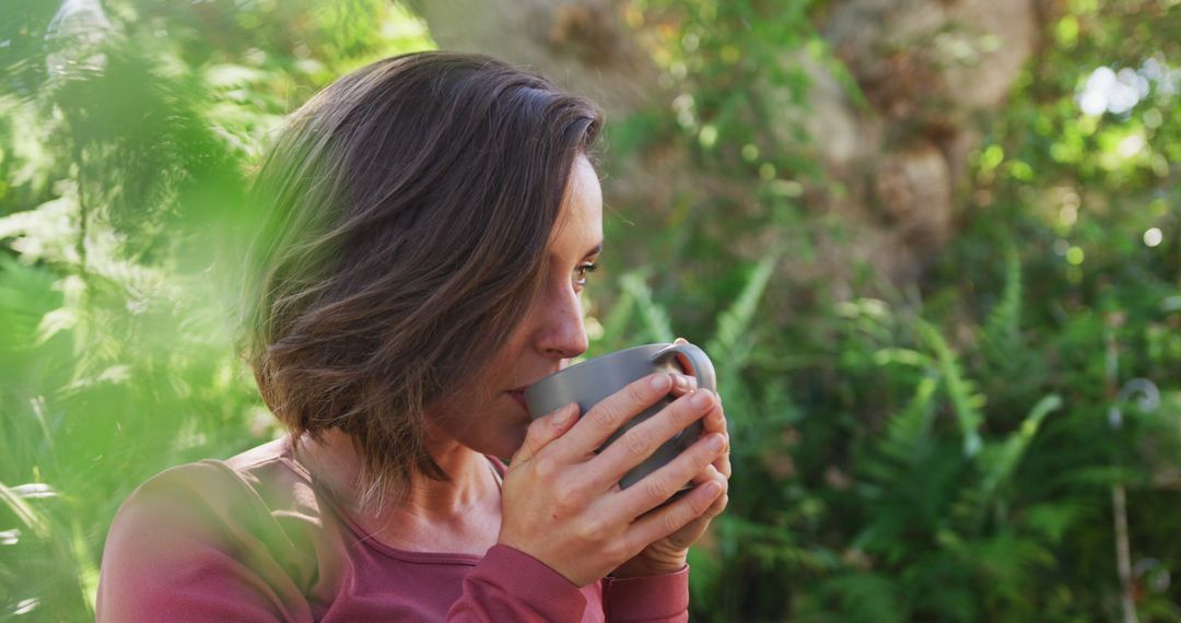 Woman Enjoying Coffee in Nature Surrounded by Greenery - Free Images, Stock Photos and Pictures on Pikwizard.com