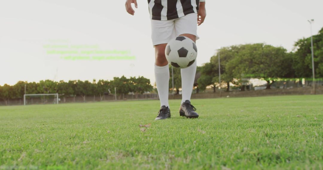 Male Soccer Player Practicing Ball Juggling on Field