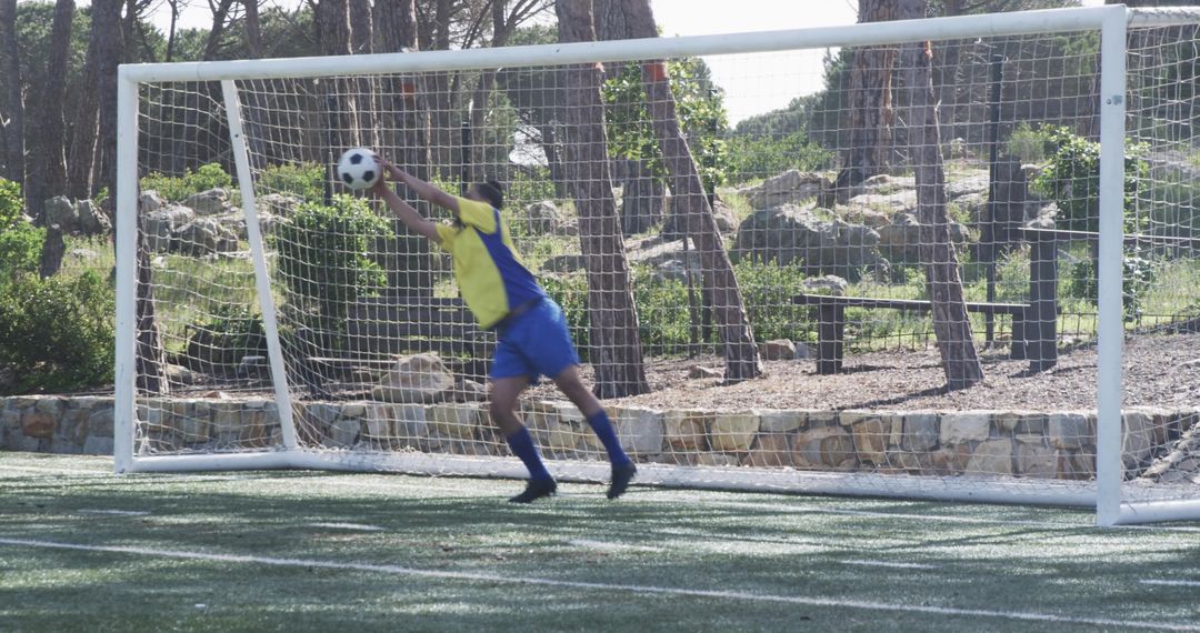 Soccer Goalie in Action Ready to Defend Goal During Match