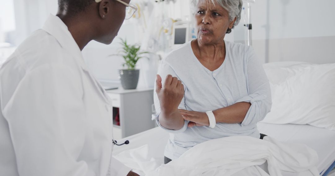 Doctor Discussing Health Concerns with Senior Patient in Hospital Room - Free Images, Stock Photos and Pictures on Pikwizard.com