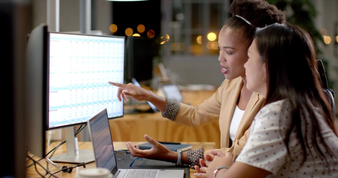 Diverse Businesswomen Collaborating on Sales Analysis