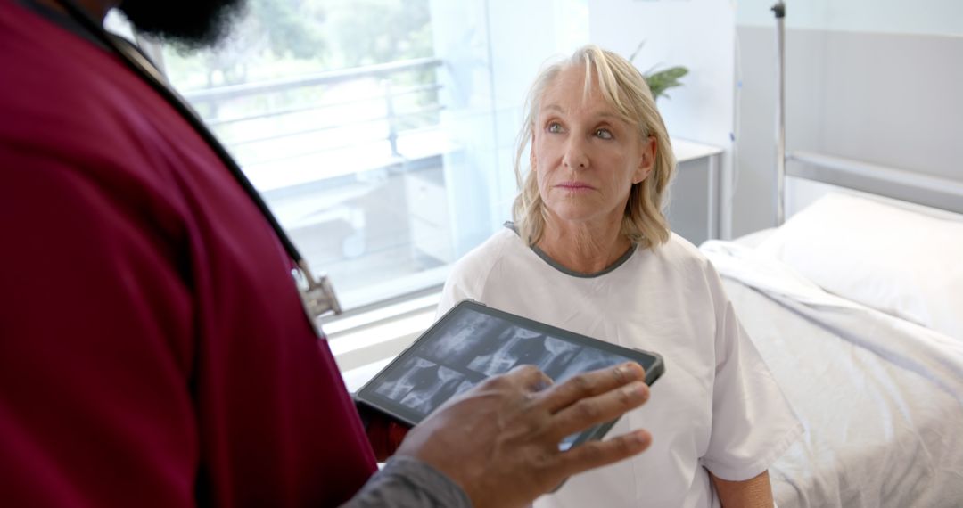 Senior Woman Consulting with Doctor about X-Ray Results in Modern Hospital Room - Free Images, Stock Photos and Pictures on Pikwizard.com