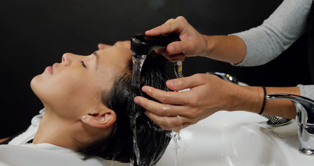 Woman Relaxing While Hair Stylist Washes Hair in Salon - Free Images, Stock Photos and Pictures on Pikwizard.com