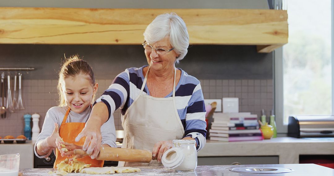 Senior Woman Teaching Young Girl Baking with Dough in Kitchen - Free Images, Stock Photos and Pictures on Pikwizard.com