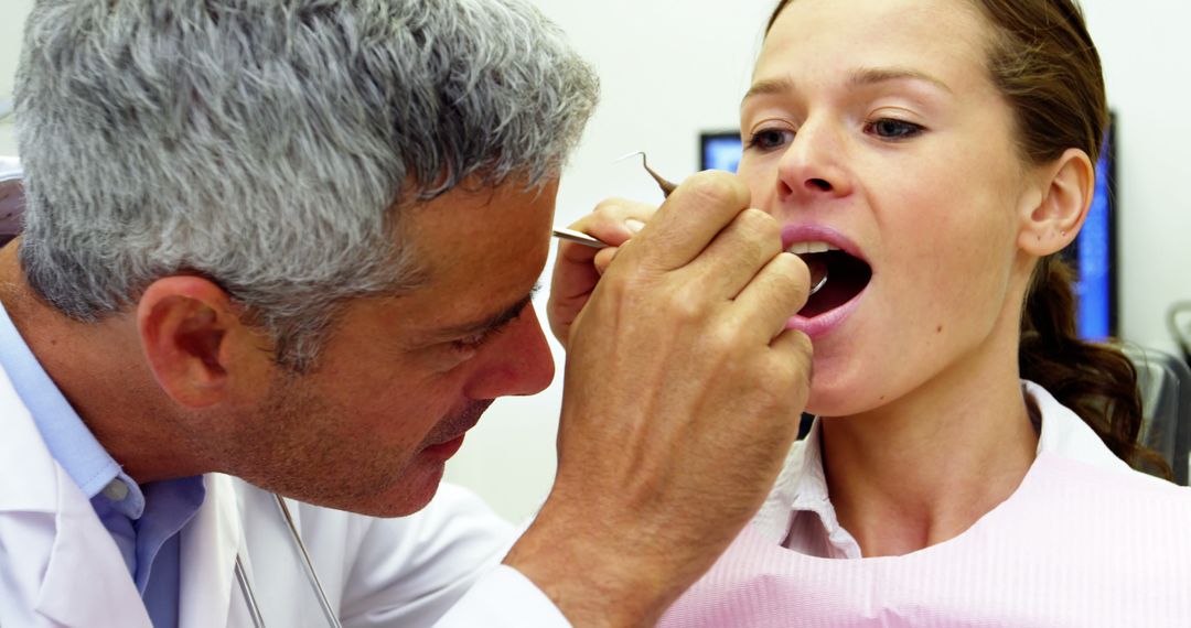 Dentist Examining Patients Teeth With Dental Tools - Free Images, Stock Photos and Pictures on Pikwizard.com