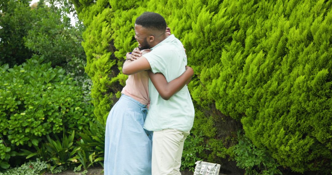 Young Couple Embracing in Lush Garden Setting