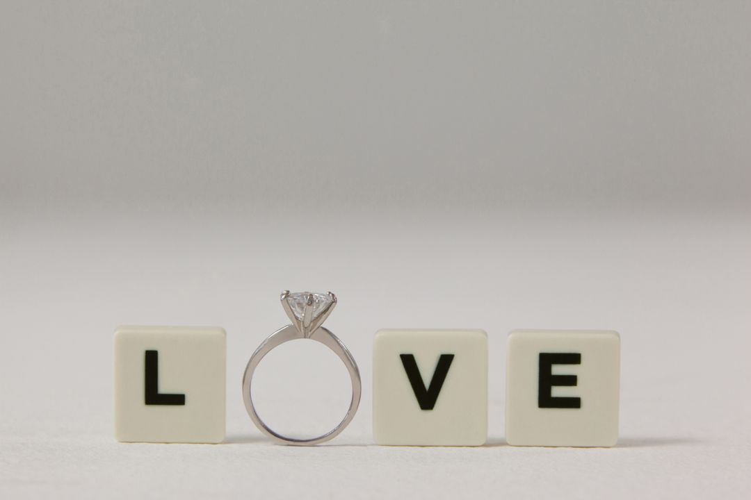 Diamond ring between white blocks displaying love message - Free Images, Stock Photos and Pictures on Pikwizard.com