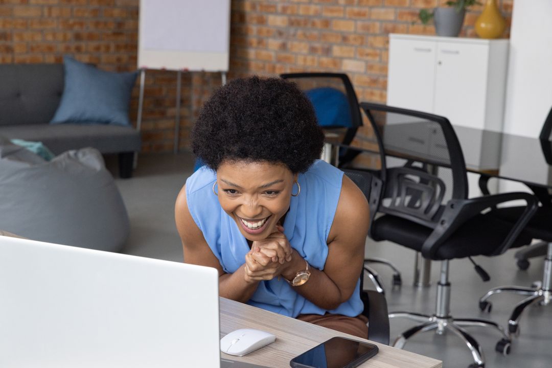 Enthusiastic Professional on Laptop in Modern Workspace