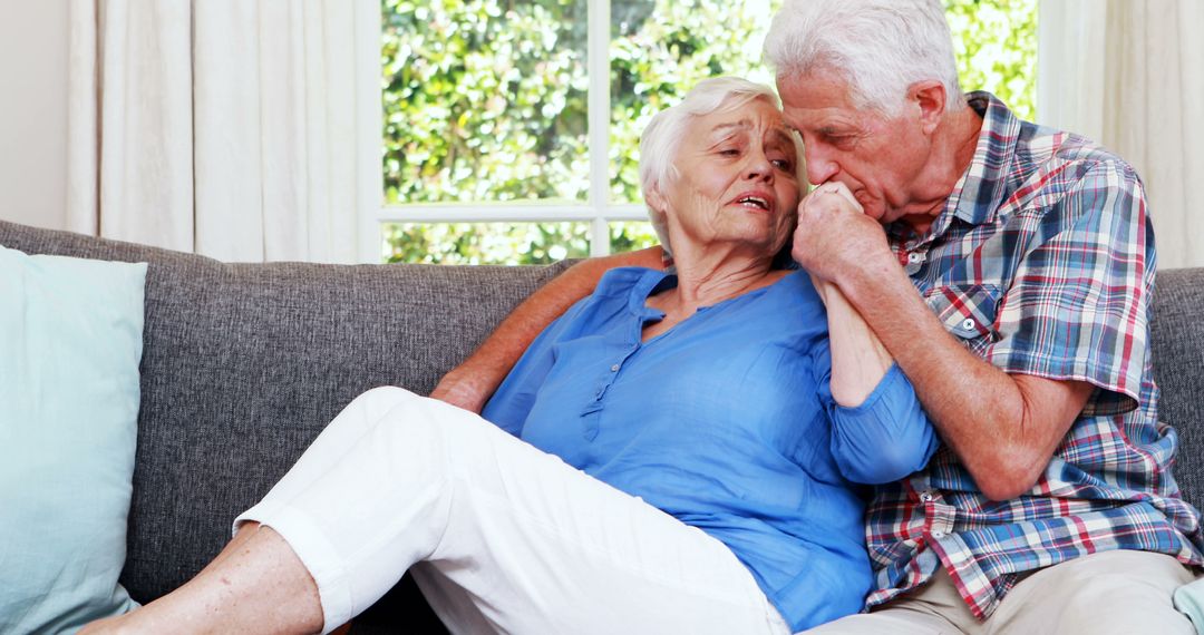 Senior Couple Embracing and Comforting Each Other on Couch - Free Images, Stock Photos and Pictures on Pikwizard.com