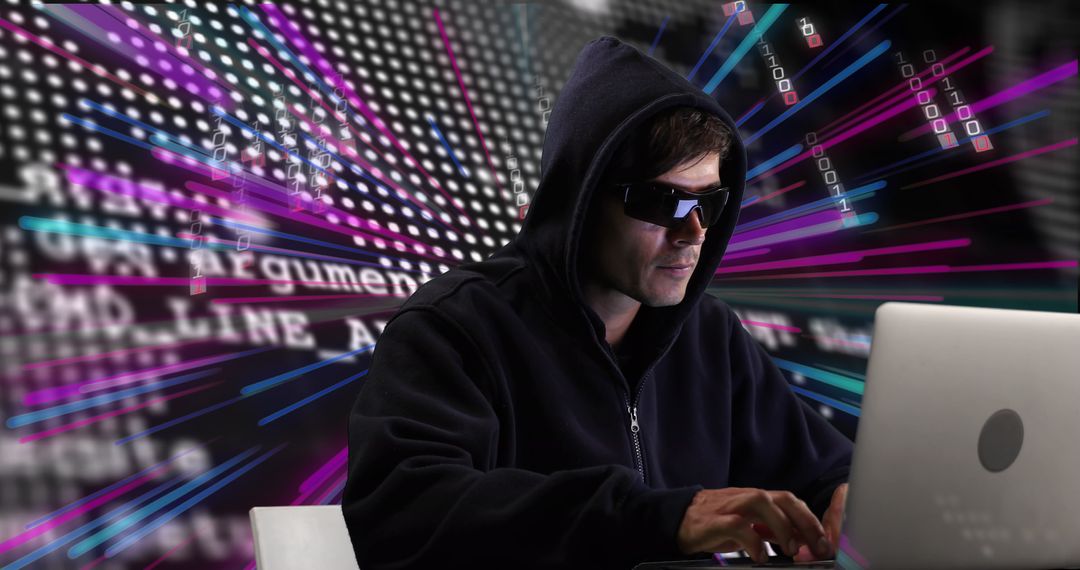 Mysterious Hacker Working on Laptop with Neon Light Effects